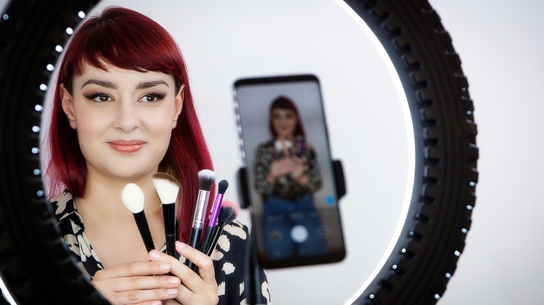 Woman doing makeup for TikTok
