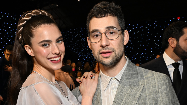Margaret Qualley in a light blue dress with a headband braid with Jack Antonoff at an event