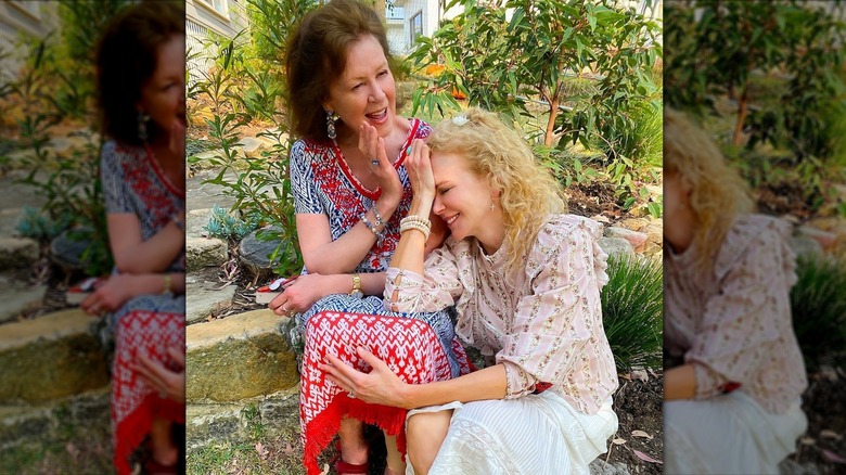 Nicole Kidman with curly hair laughing while leaning on her mother's lap