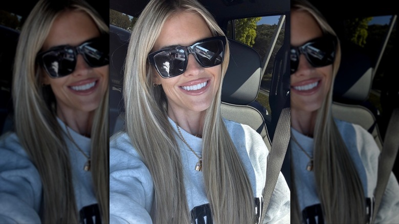 Christina Haack in the car in a grAy sweatshirt