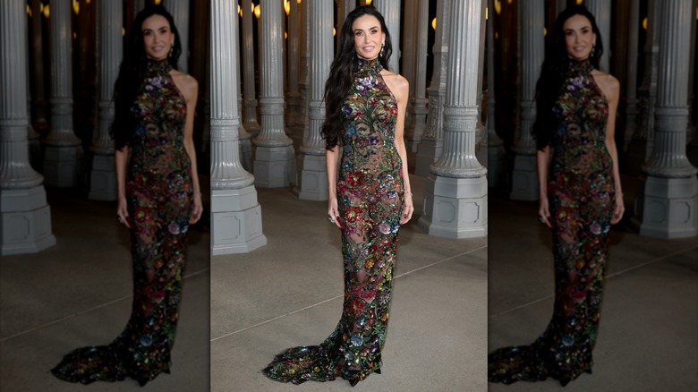 Demi Moore wearing a sheer, figure-hugging dress adorned with flowers at the LACMA Art+Film Gala