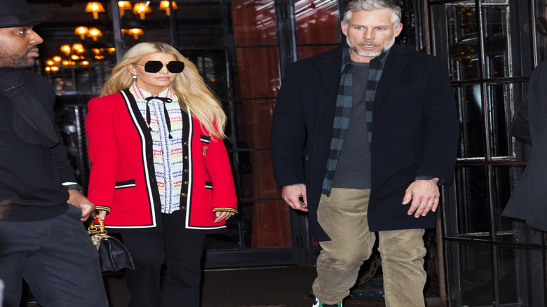 Jessica Simpson with sunglasses on and Eric Johnson in a black coat in New York City