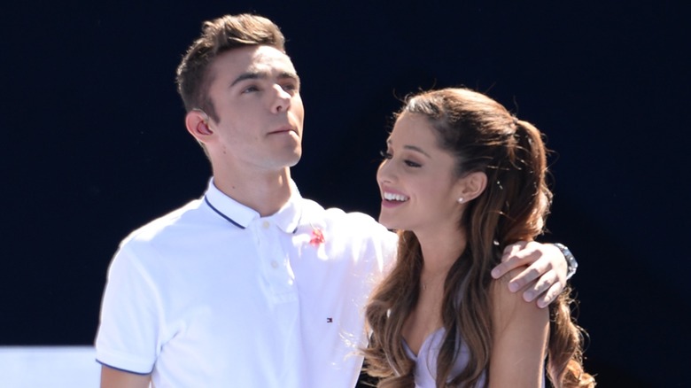 Nathan Sykes with his arm around Ariana Grande