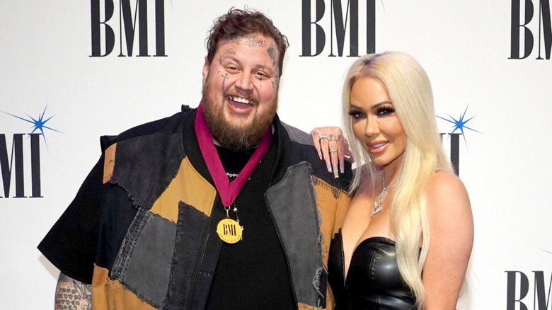 Jelly Roll smiling with Bunnie Xo on the red carpet