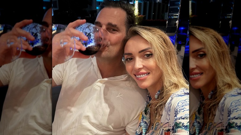 Bill Rancic drinking while posing with Giuliana Rancic