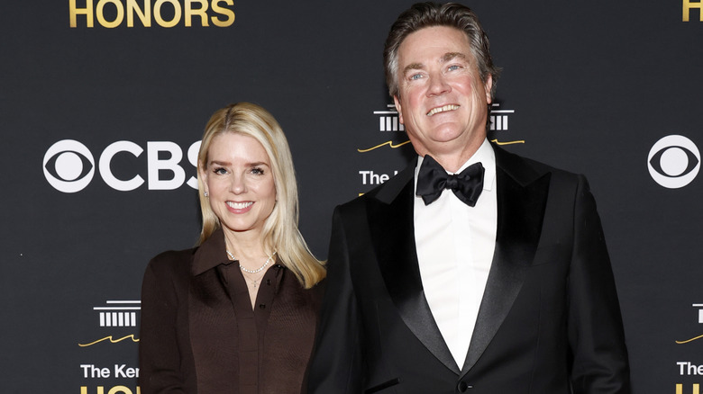 Pam Bondi and John Wakefield smiling on red carpet