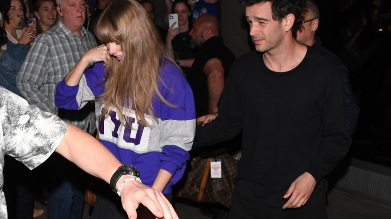 Taylor Swift walking next to Matty Healy