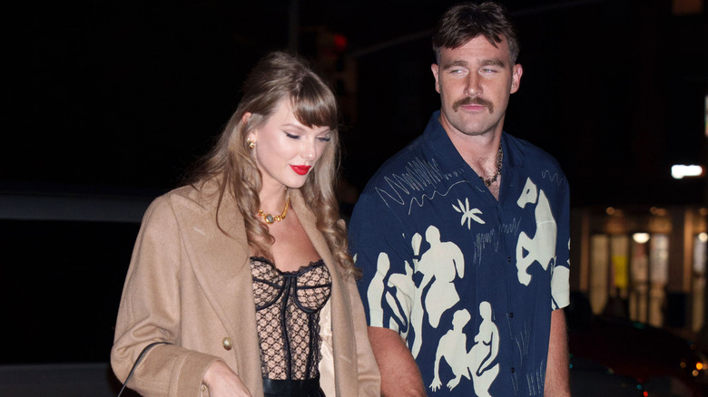 Taylor Swift and Travis Kelce walking hand-in-hand