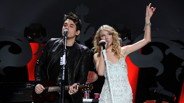 Taylor Swift performing onstage next to John Mayer
