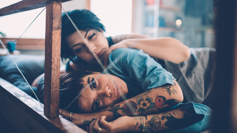 lesbian couple arguing in bed