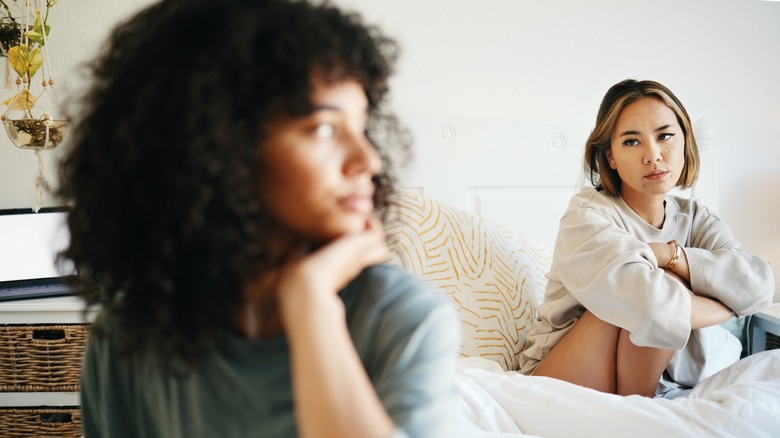 lesbian couple arguing in bed
