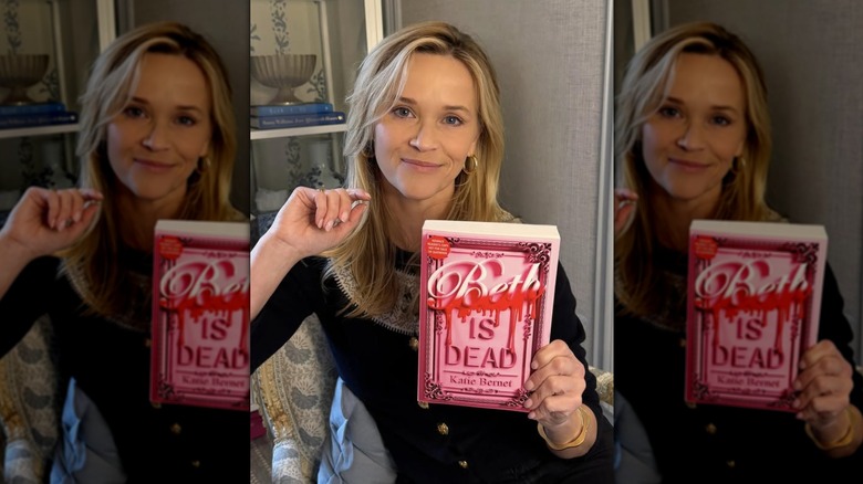 Reese Witherspoon holding a copy of the book "Beth Is Dead"
