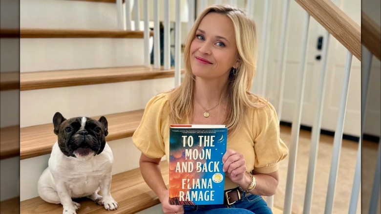 Reese Witherspoon holding To the Moon and Back by Eliana Ramage