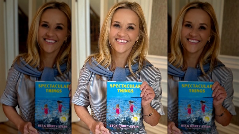 Reese Witherspoon holding Spectacular Things by Beck Dorey-Stein