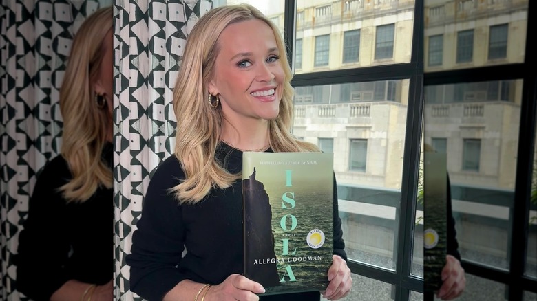 Reese Witherspoon holding a copy of Isola by Allegra Goodman