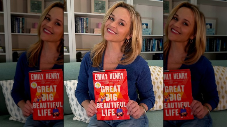 Reese Witherspoon holding Great Big Beautiful Life by Emily Henry