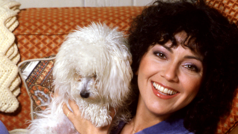 Joyce DeWitt posing at her home with her dog in 1980