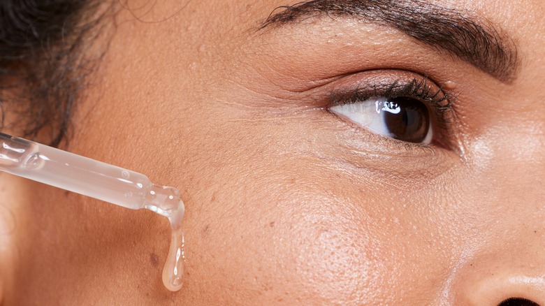 Woman applying serum