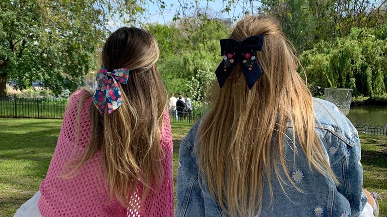Two women with bows in their hair from the back