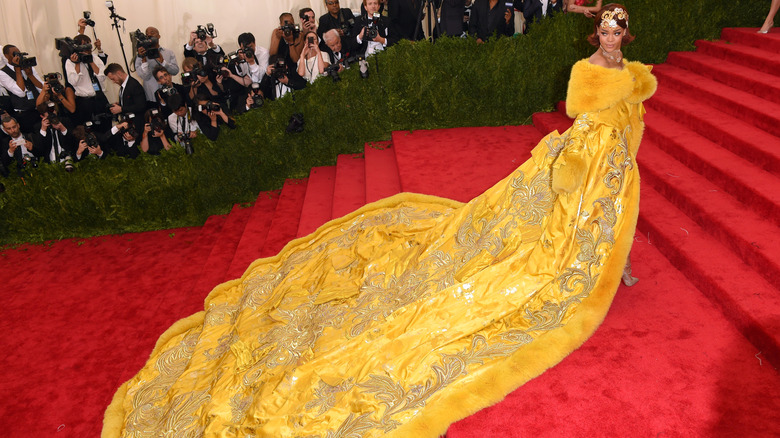 Rihanna at the 2015 Met Gala in a yellow silk and fur gown