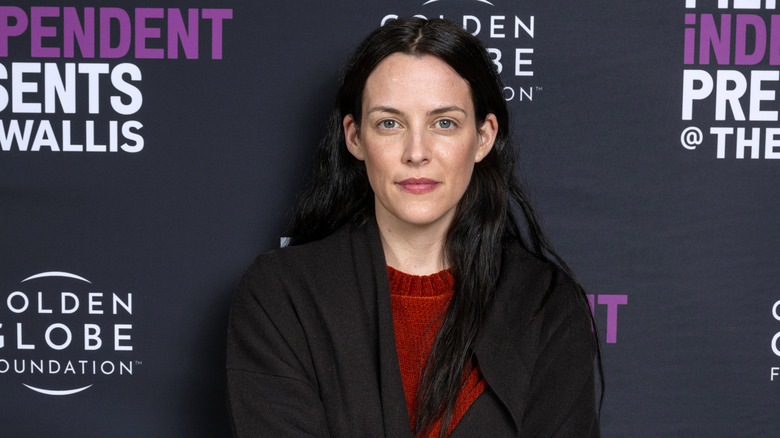 Riley Keough posing with a small smile at a film festival event