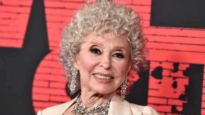 Rita Moreno smiles with curly white hair