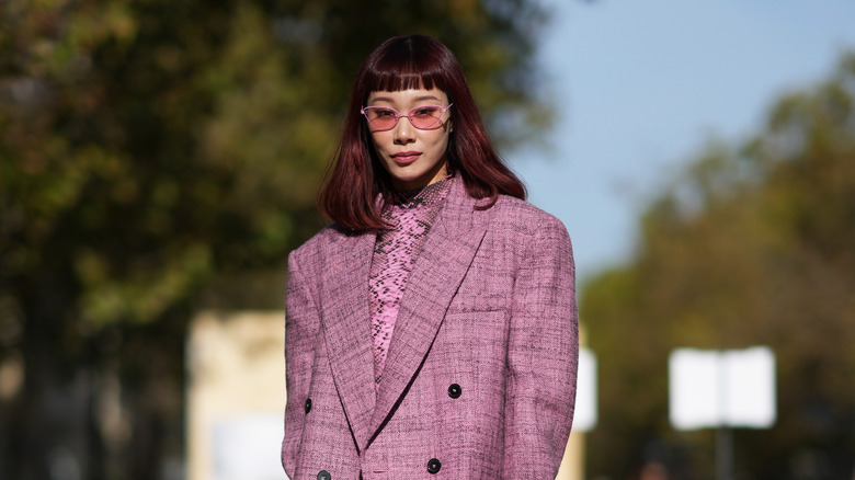 A woman wearing rose-tinted sunglasses 