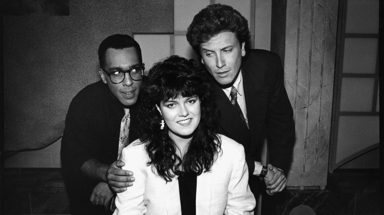 Black-and-white photo showing Rosie O'Donnell posing with her fellow VH1 VJs Bobby Rivers and Roger Rose in 1988