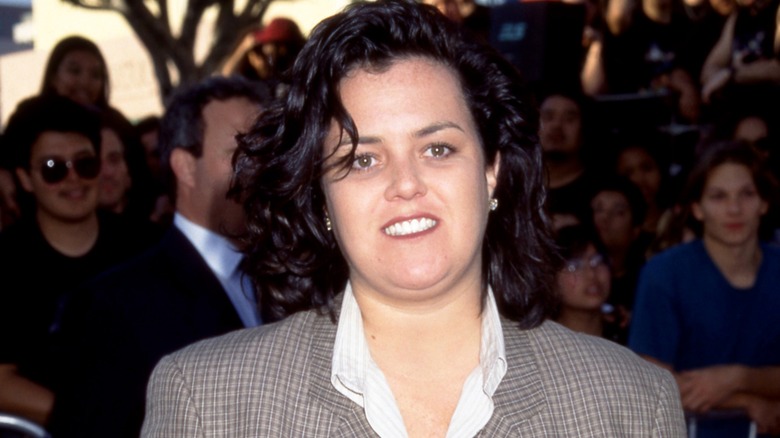 Rosie O'Donnell posing on the red carpet in a check blazer in 1995