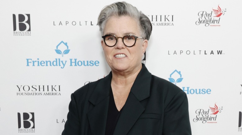 Rosie O'Donnell smiling on the red carpet with short, gray hair at the Friendly House 33rd Annual Awards Luncheon in 2023