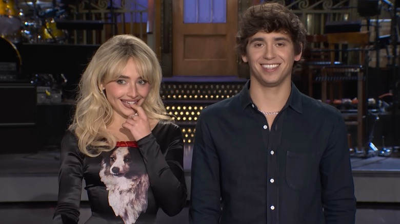 Sabrina Carpenter and Marcello Hernández standing together in promo for SNL