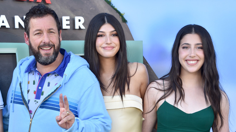 Adam Sandler, Sunny Sandler, and Sadie Sandler all smile on the red carpet