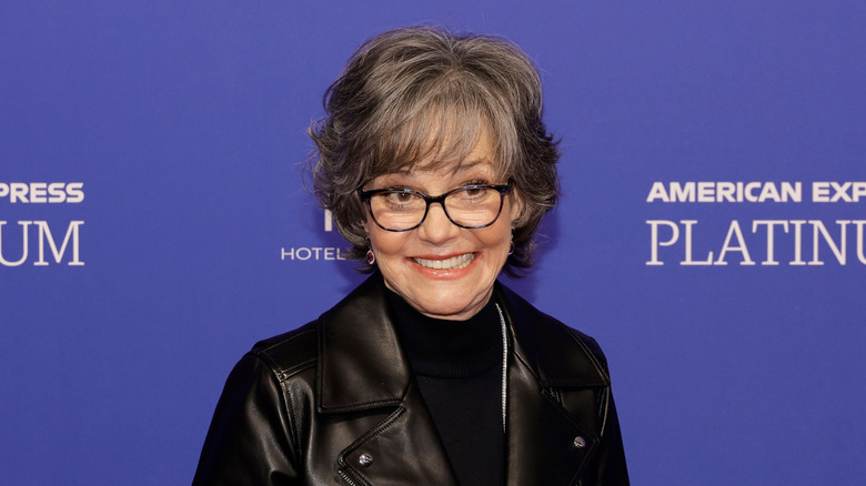 Sally Field in a black leather blazer and black turtleneck