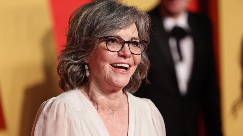 Sally Field in blue glasses and white dress