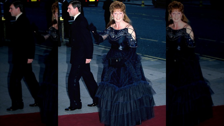 Sarah Ferguson in a navy gown walking a red carpet in 1988