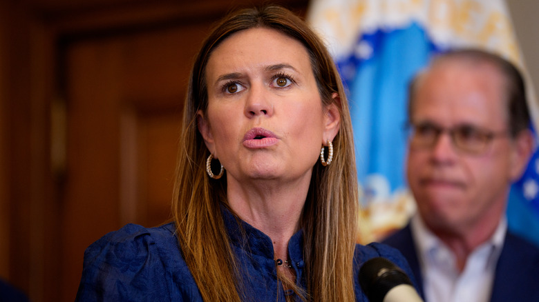 Sarah Huckabee Sanders wears dark blue floral dress