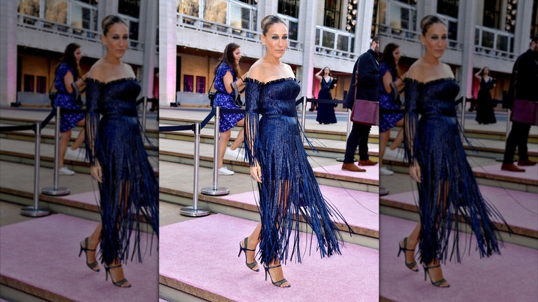 Sarah Jessica Parker poses wearing a navy metallic dress with a fringe skirt