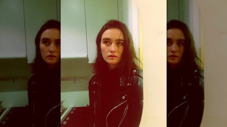 Sarah Pidgeon posing with her brown hair worn in a messy side-part