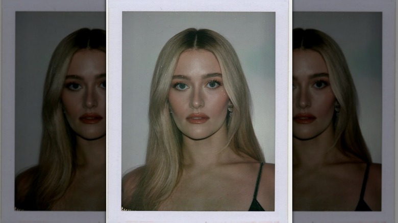 Polaroid of Sarah Pidgeon wearing her light blonde hair in a middle-part with dark roots