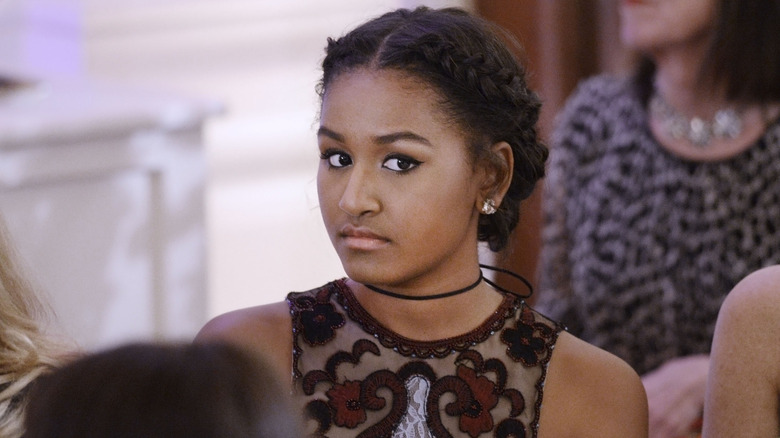 Sasha Obama looks confused in a black choker and mesh black dress