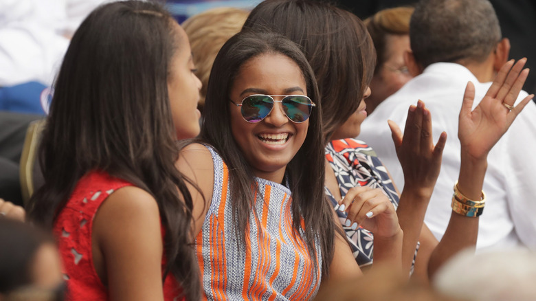 Malia Obama, Sasha Obama, U.S. first lady Michelle Obama and President Barack Obama react to the first run scored during an exhibition game between the Cuban national baseball team and Major League Baseball's Tampa Bay Devil Rays at the Estado Latinoamericano March 22, 2016