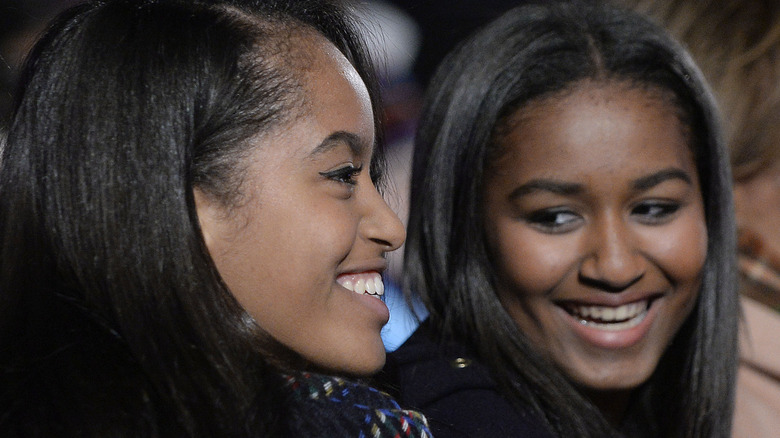 Malia and Sasha Obama attend the national Christmas tree lighting ceremony on the Ellipse south of the White House December 3, 2015