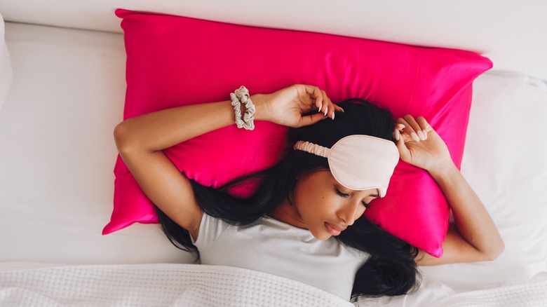 woman sleeping on satin pillowcase