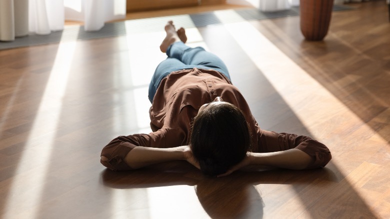 Woman lying on the floor in sun 