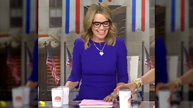 Savannah Guthrie smiling on Today while sitting behind a desk in a blue dress