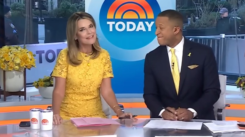 Savannah Guthrie wearing a yellow dress while sitting alongside Craig Melvin on Today