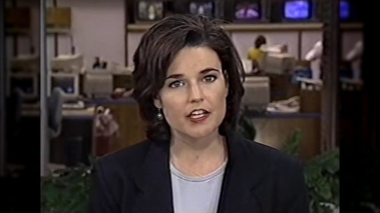 Still of Savannah Guthrie with a dark hairstyle on a news segment in the '90s