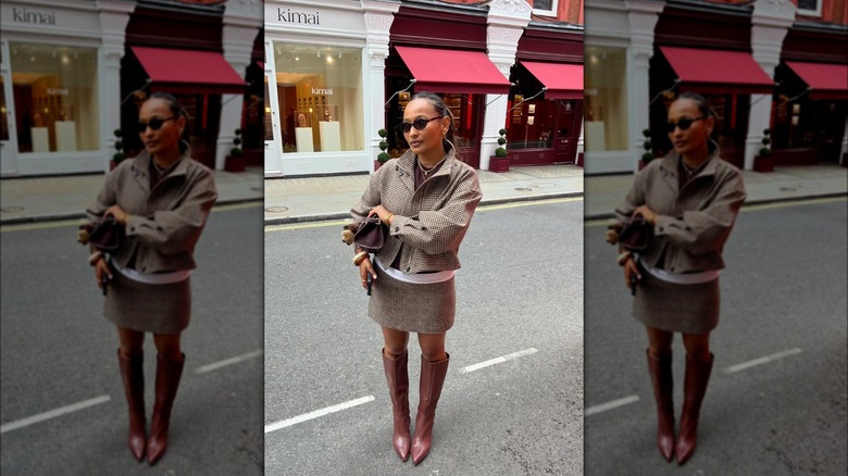 A woman on the street wearing a brown tweed matching skirt and jacket set