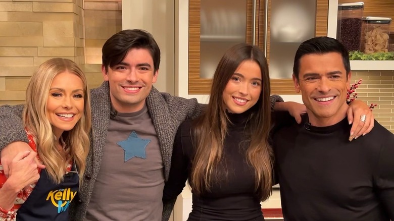 Kelly Ripa and Mark Consuelos with two of their three children on set