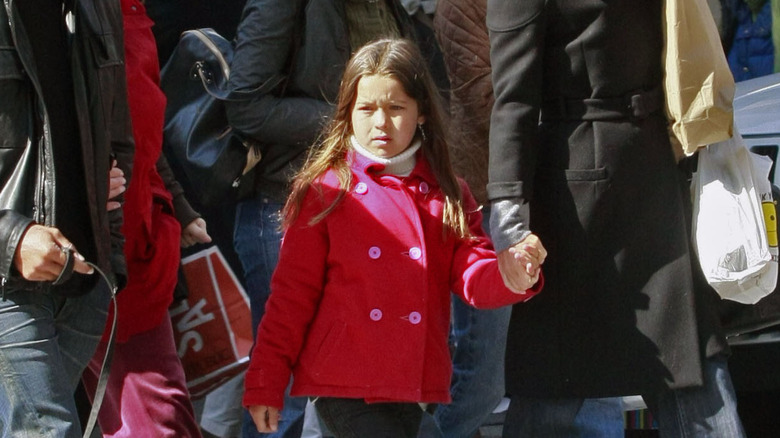 Lola Consuelos walking and holding Kelly Ripa's hand